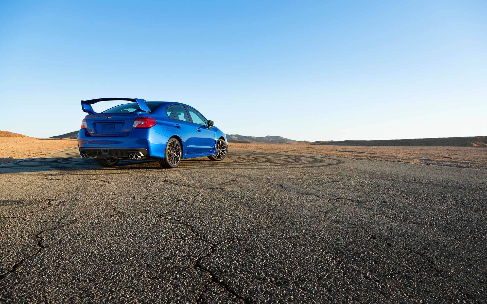 2019 Subaru WRX blue pearl over cracked ground
