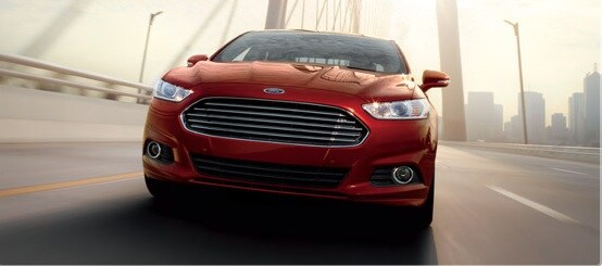 2016 Ford Fusion driving out of a city