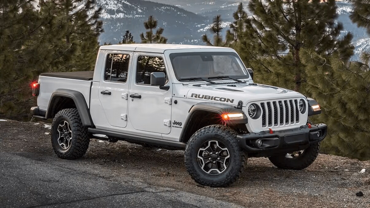 Exterior shot of a silver Jeep Gladiator Rubicon parked alongside a road in the mountains