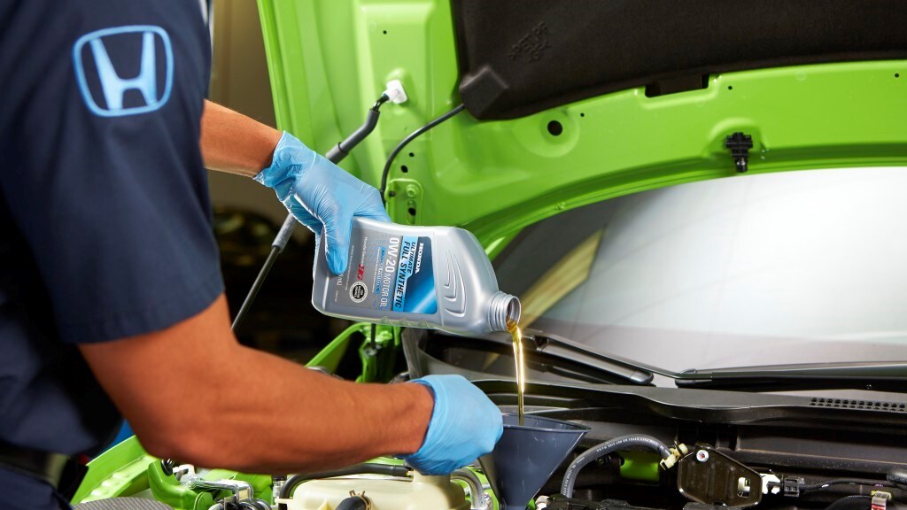 Honda Express Service at AutoNation Honda 104 Man changing oil in a car