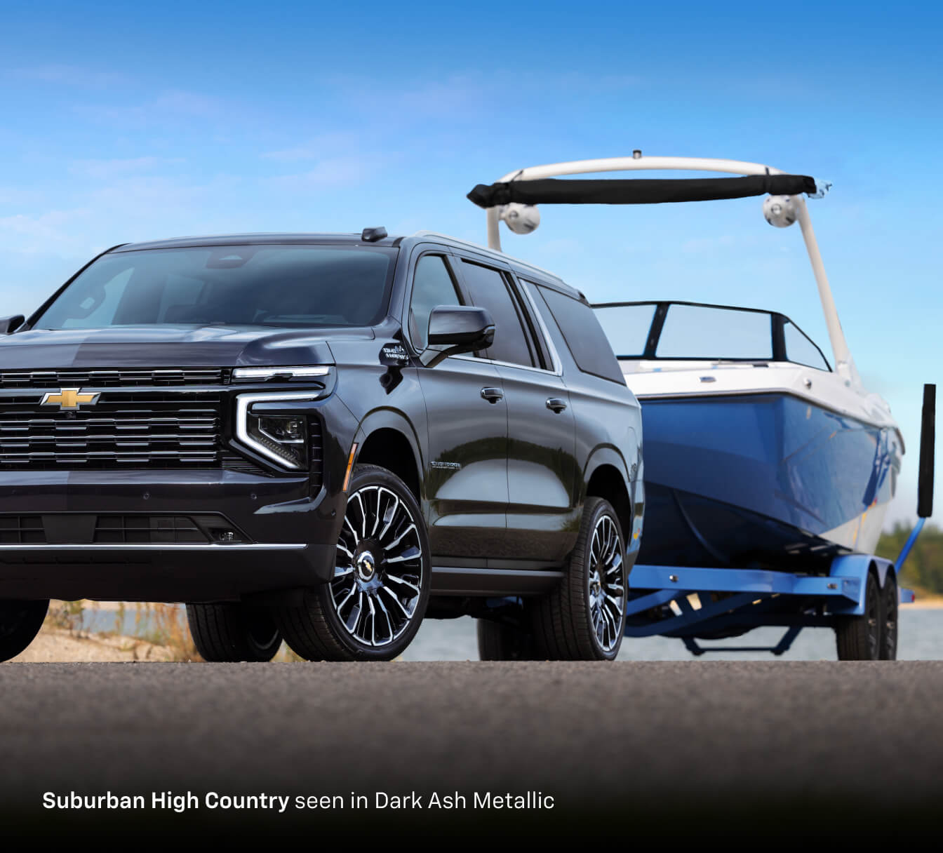 2026 Chevrolet Suburban Z71 in Cypress Green, front close-up and three-quarter view driving off-road.