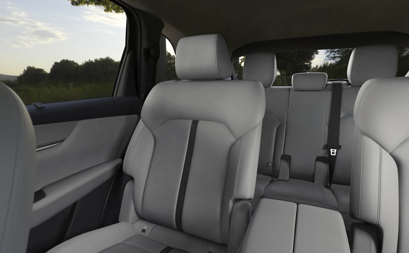 Light-colored three-row seating inside the Mazda CX-90 cabin.