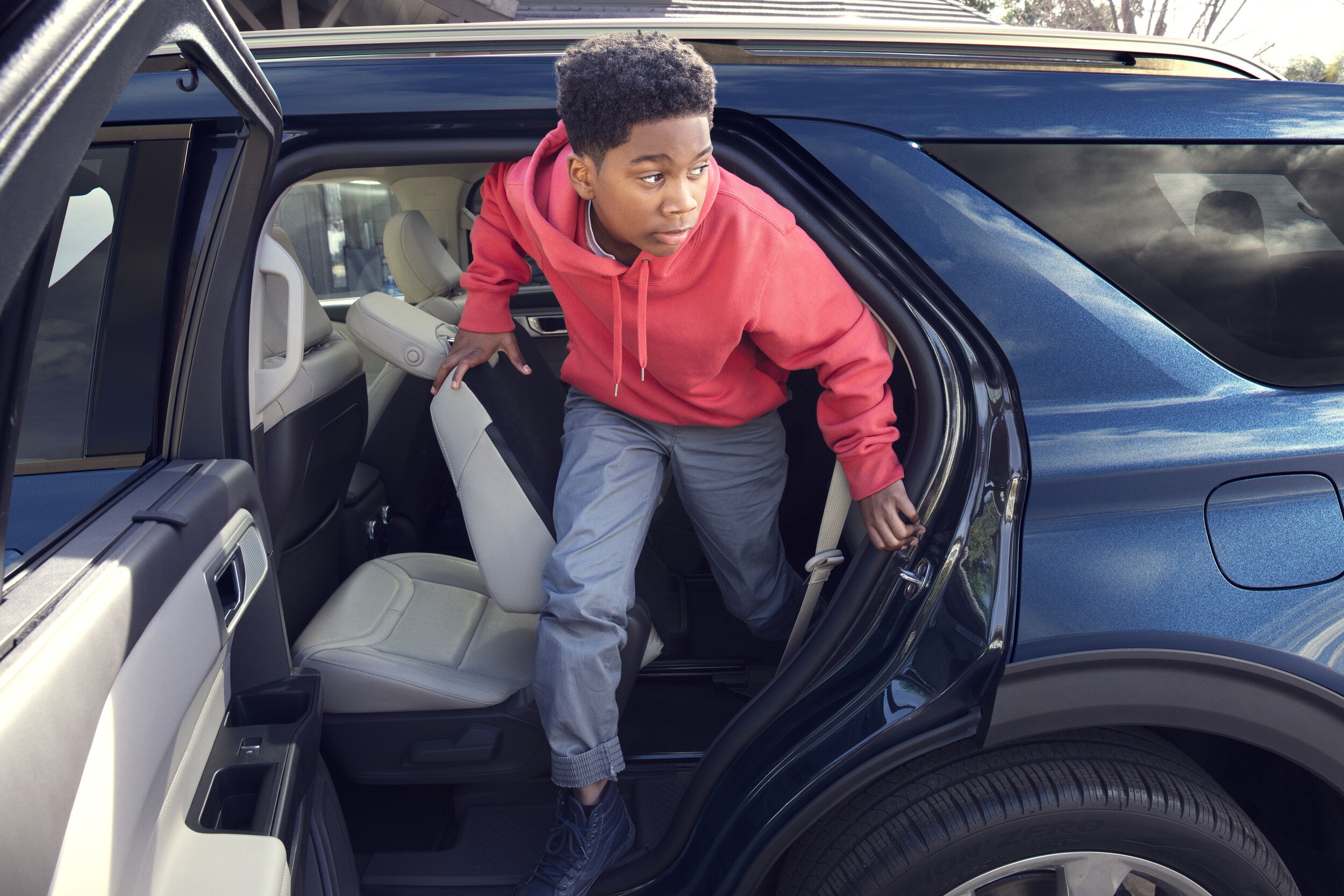 kid climbing out of 2020 ford explorer.jpeg kid climbing out of 2020 ford explorer