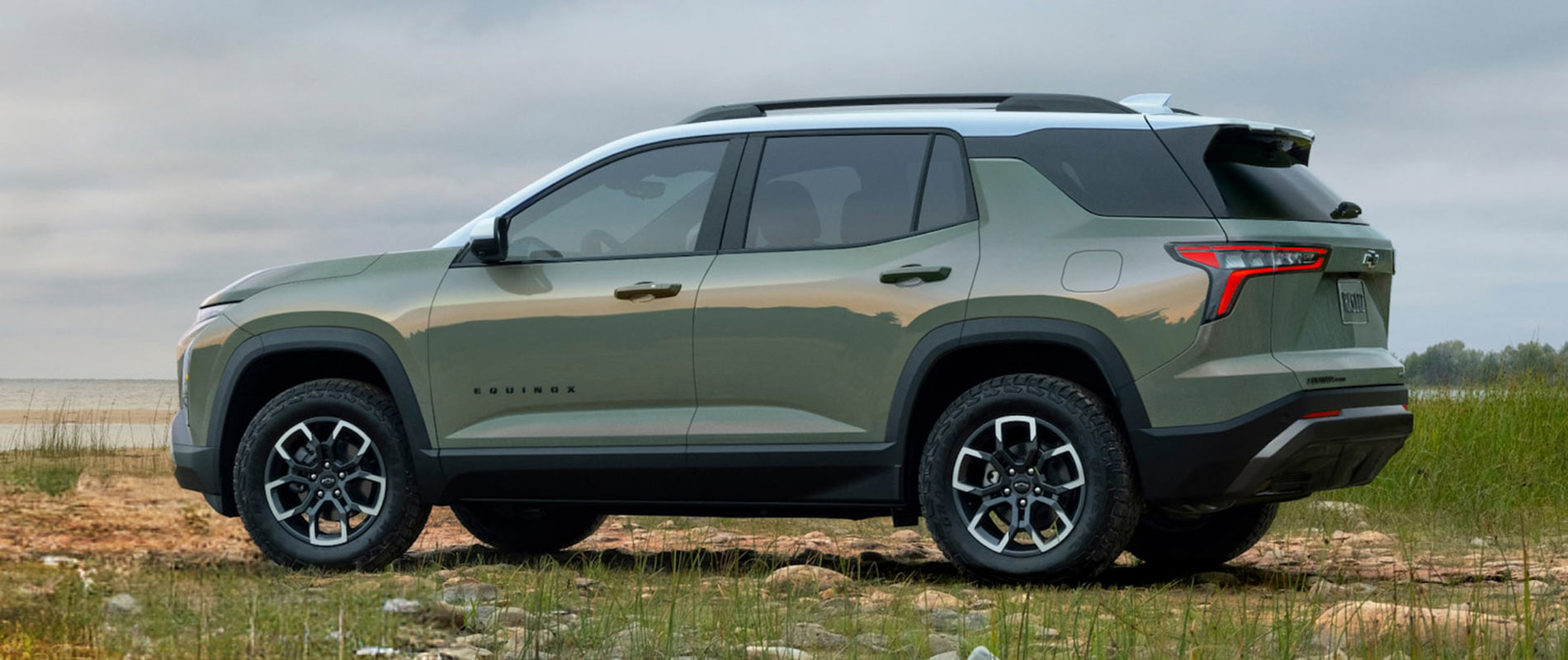2026 Chevy Equinox Trim Comparison A green 2026 Chevrolet Equinox parked near a beach.
