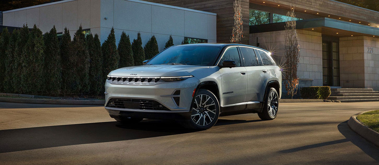 Jeep Dealer Near Williston A light blue Jeep Wagoneer S parked in a driveway.