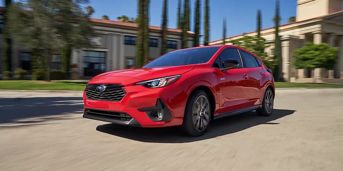 Red 2024 Subaru Impreza RS in motion