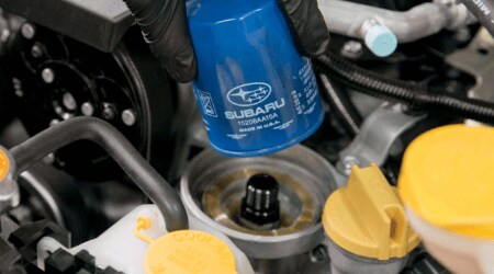 Subaru Maintenance Schedule Subaru technician replacing Subaru parts