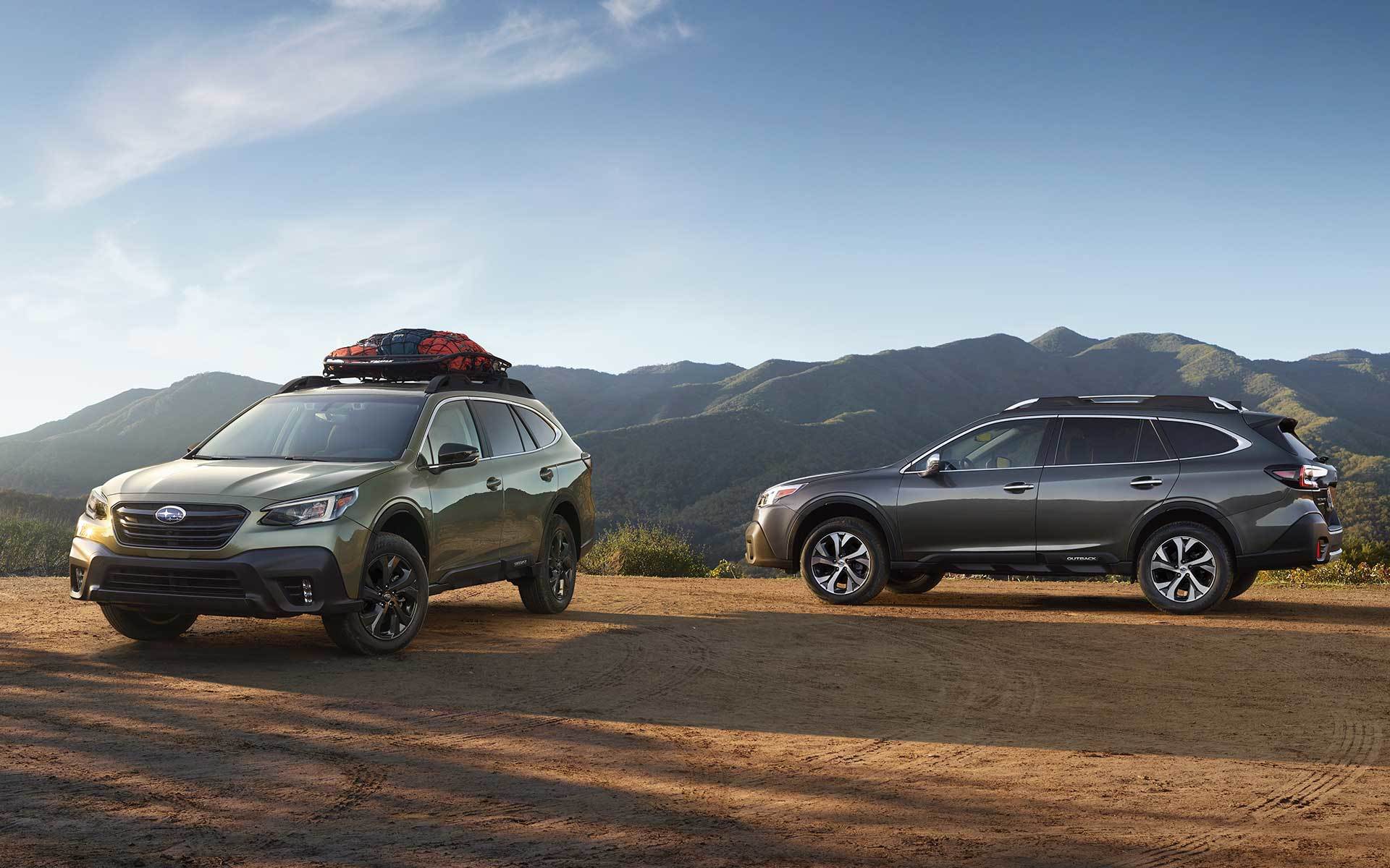 22_OBK_photos_ext_02.jpg two 2022 Subaru Outbacks parked in the mountains with camping gear on top of one car