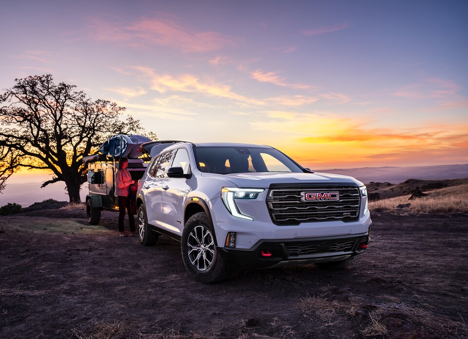 New GMC Acadia towing camper and kayaks