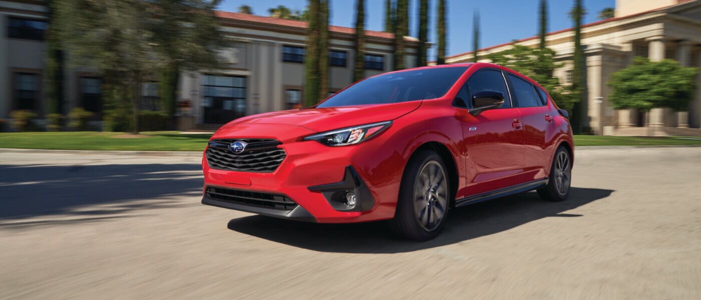 2025 Subaru Impreza Exterior Turning In Front Of Town Buildings