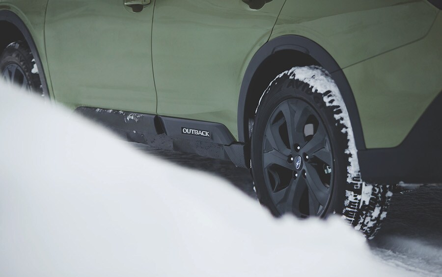 Subaru Outback driving in the snow