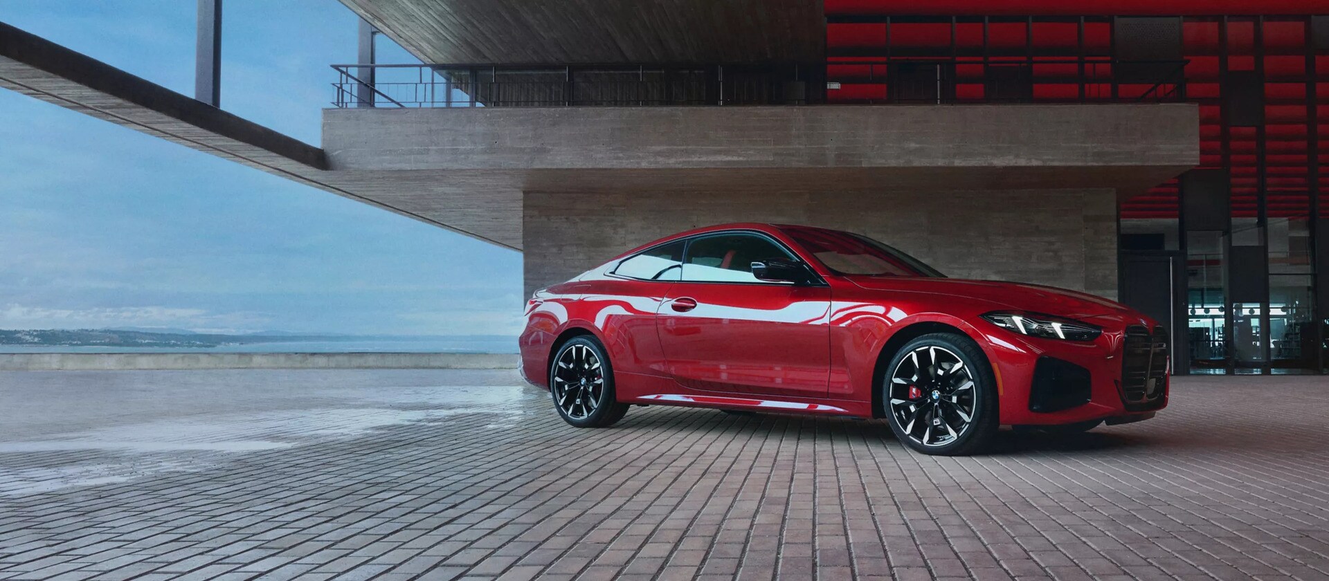 a brand new look at the 2026 BMW 4 Series parked on a brick road next to a building