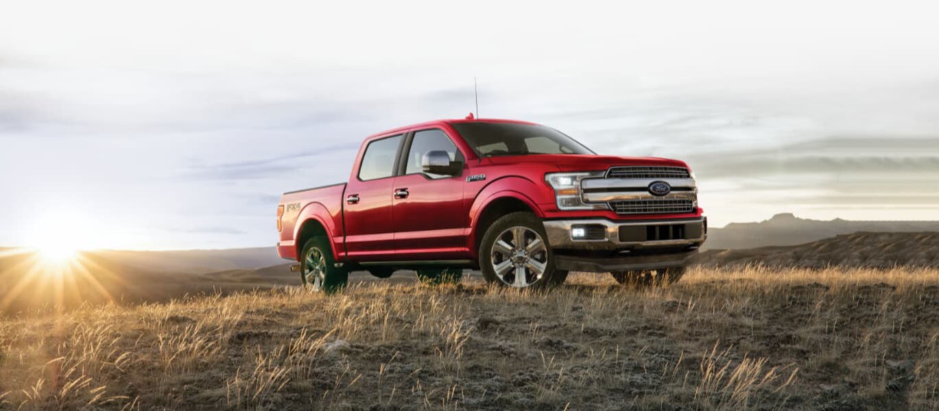 A red 2020 Ford F-150 parked on a hill