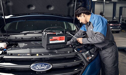 Ford Financing Ford service technician changing car battery