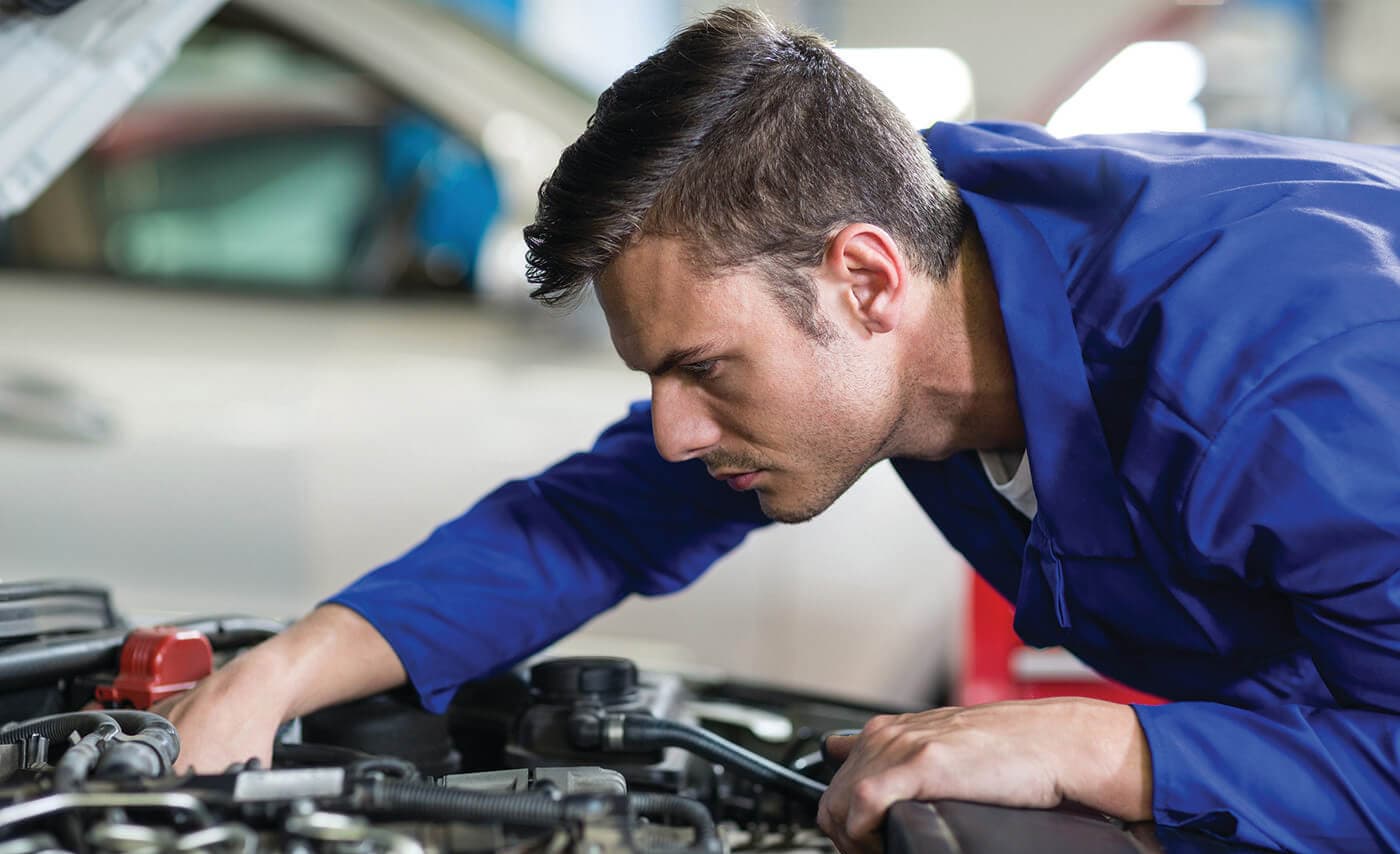 A Ford service worker changing oil