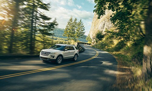 2019 Ford Explorer 2019 Ford Explorer driving down road in forest