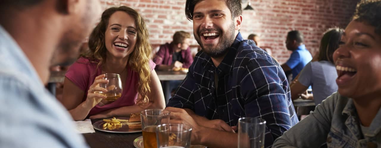 friends eating at bar restaurant_140442326