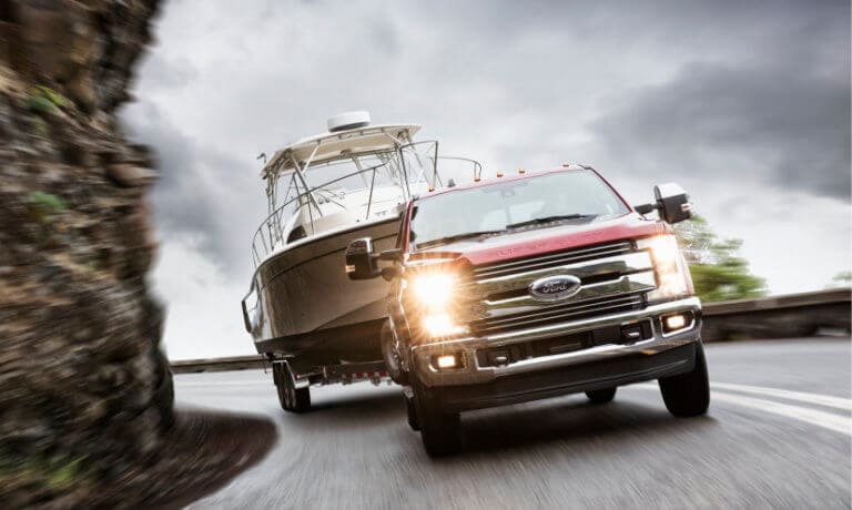 2019 Ford F-250 towing on a rocky highway curve