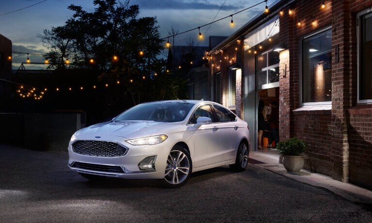 2020 Ford Fusion parked outside a garage under string lights