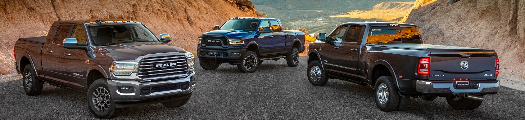 Car Dealer near Me Ram truck lineup parked on desert mountain road