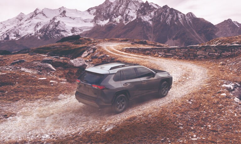 2020 RAV4 in gray drinving on dirt path off road
