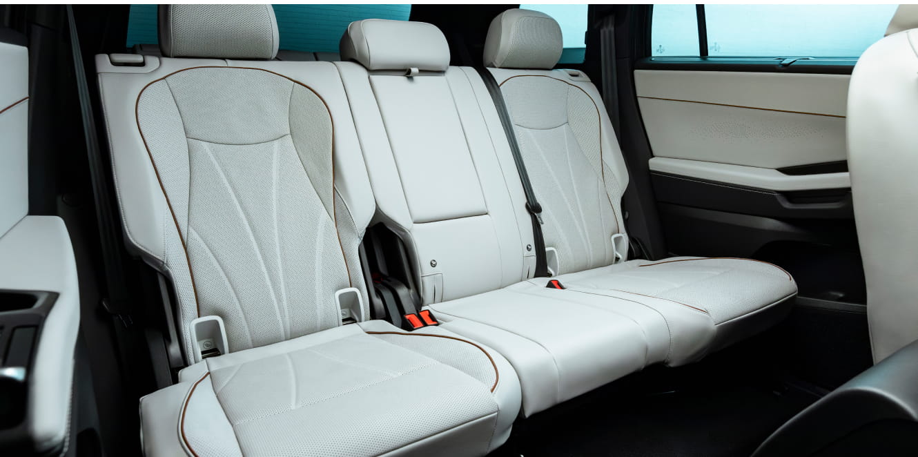 Second-row seating in the 2027 Volkswagen Atlas featuring light-colored leather upholstery with contrast piping.