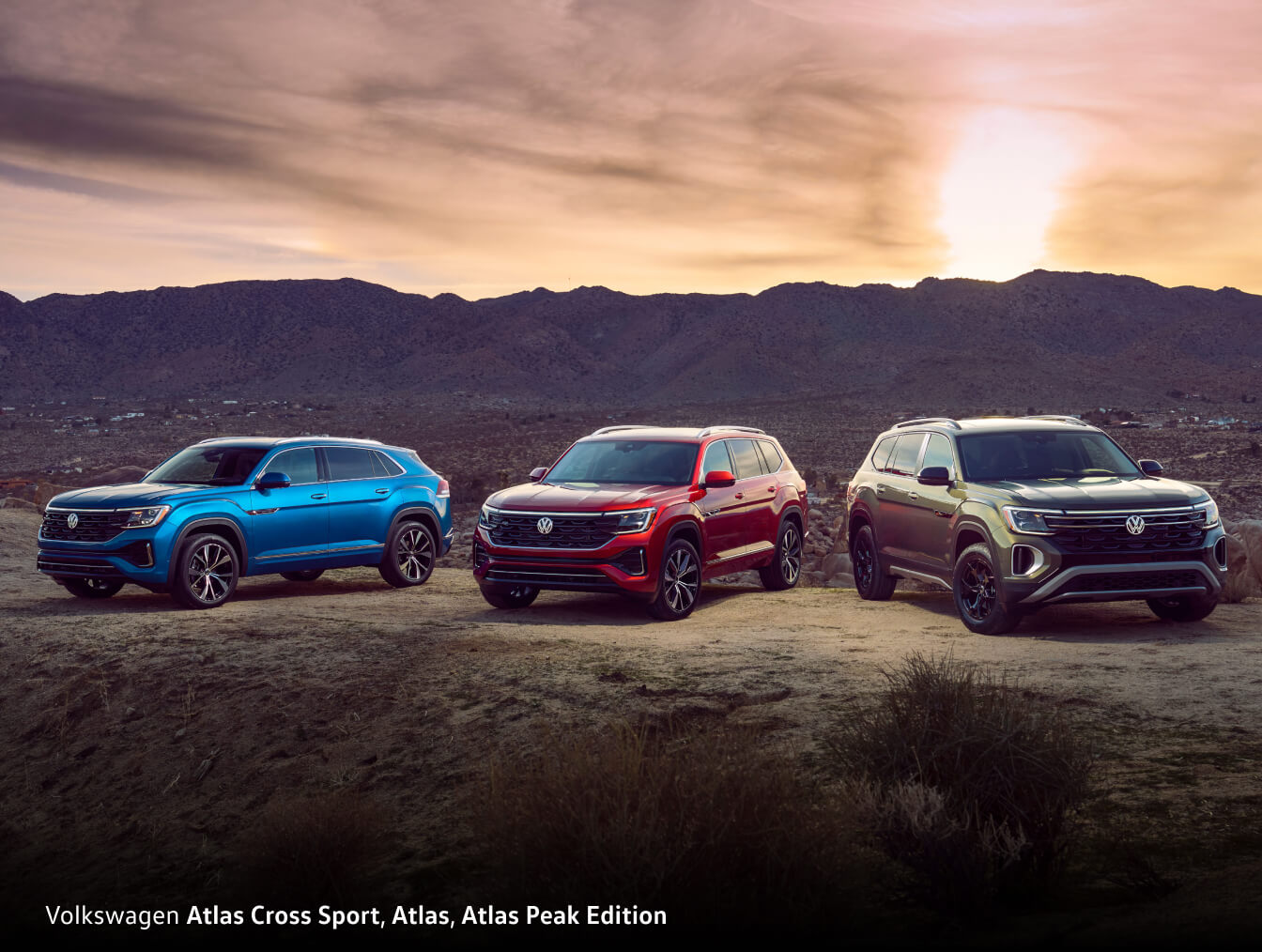 From right to left: Volkswagen Atlas Cross Sport, Atlas, Atlas Peak Edition - all three vehicles on cliffedge during sunset.