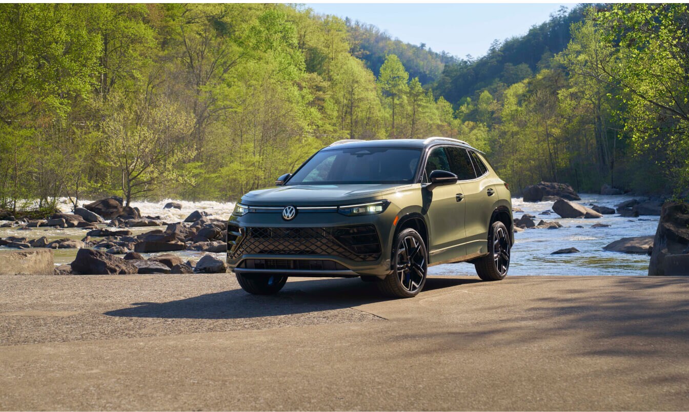 Three quarter front view of a Volkswagen Tiguan in front of a riverbed