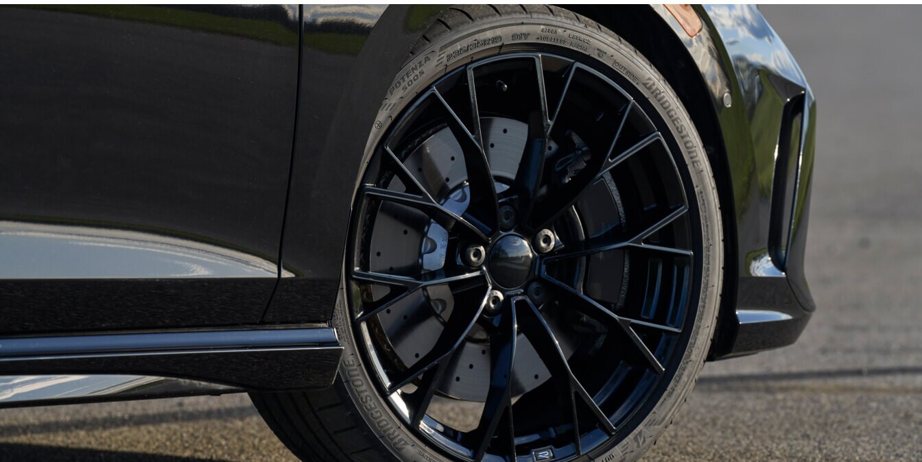 Wheel well and tire view of an AWD Volkswagen SUV with aftermarket rims