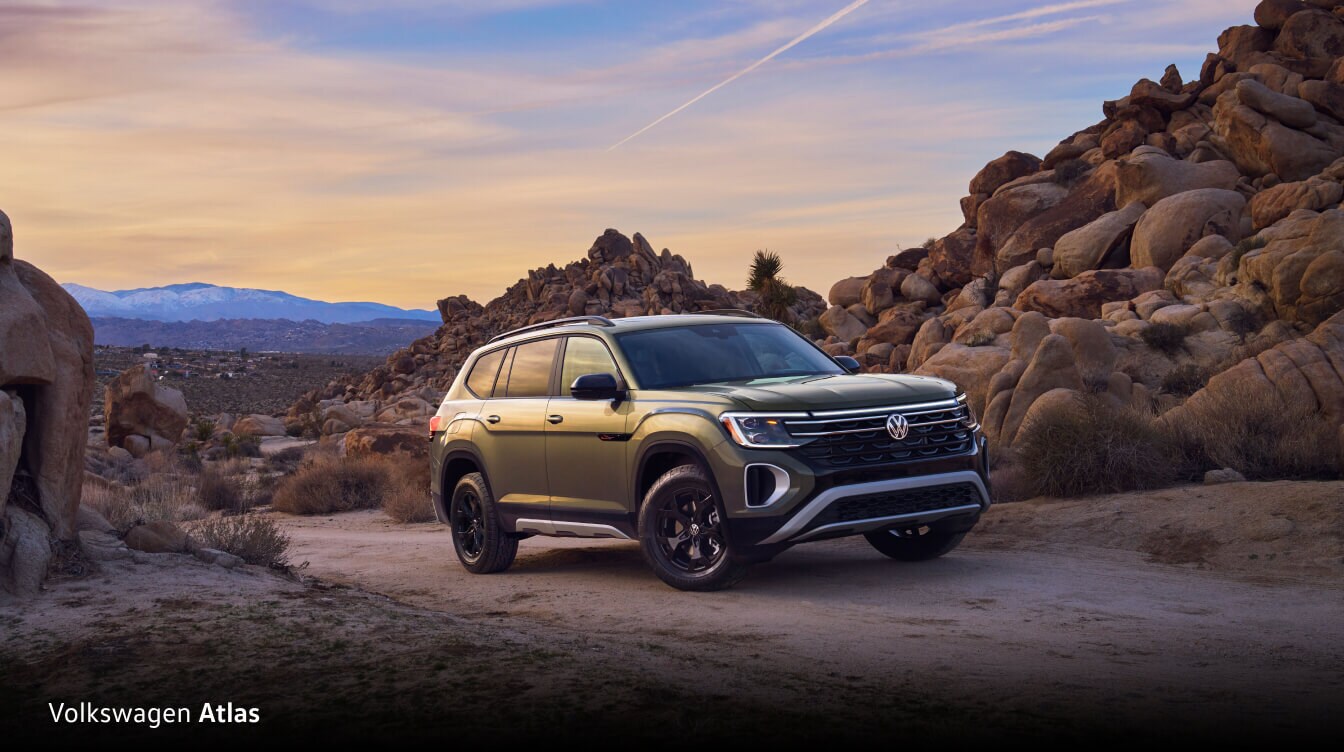 Volkswagen Atlas offroading on a canyon pass surrounded by boulders.