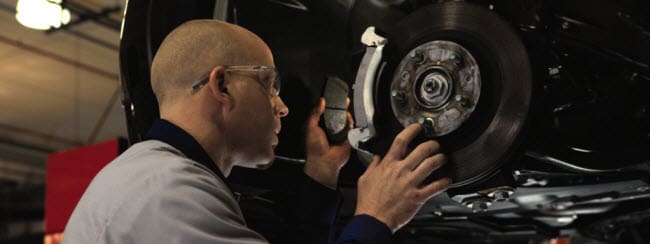 Service Tech Fixing Brakes Service Tech Fixing Brakes