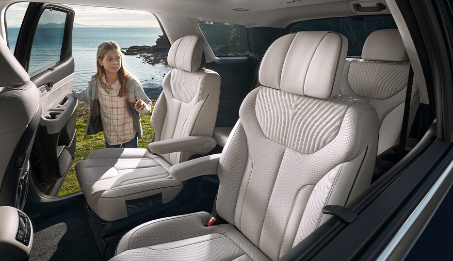 All-New 2023 Hyundai Palisade at Haddad Hyundai | Second and third row seating with a little girl about to hop in