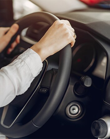 Defining GAP Insurance at Haddad Hyundai in Pittsfield, MA | Woman with both of her hands o the steering wheel of her car