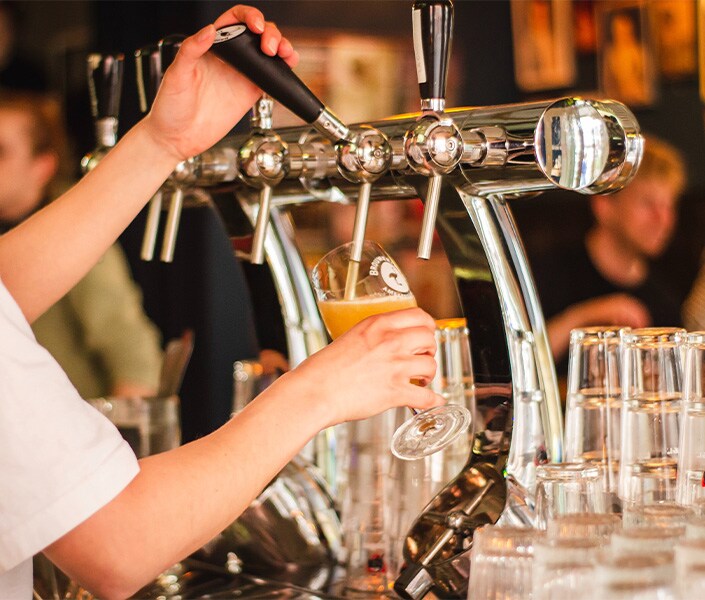 Haddad Toyota is a Toyota Dealership near Pittsfield, MA | Bartender Pouring Pint Glass of Beer in Brewery