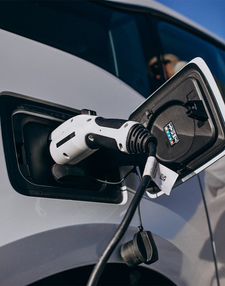 How to prepare your home for your new Electric Vehicle at Haddad Toyota in Pittsfield, MA | Close up of car charger connected to white car
