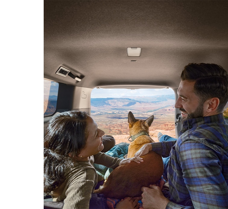 2024 Toyota Land Cruiser at Haddad Toyota in Pittsfield, MA | Couple with dog, sitting in the trunk space of a 2024 Toyota Land Cruiser