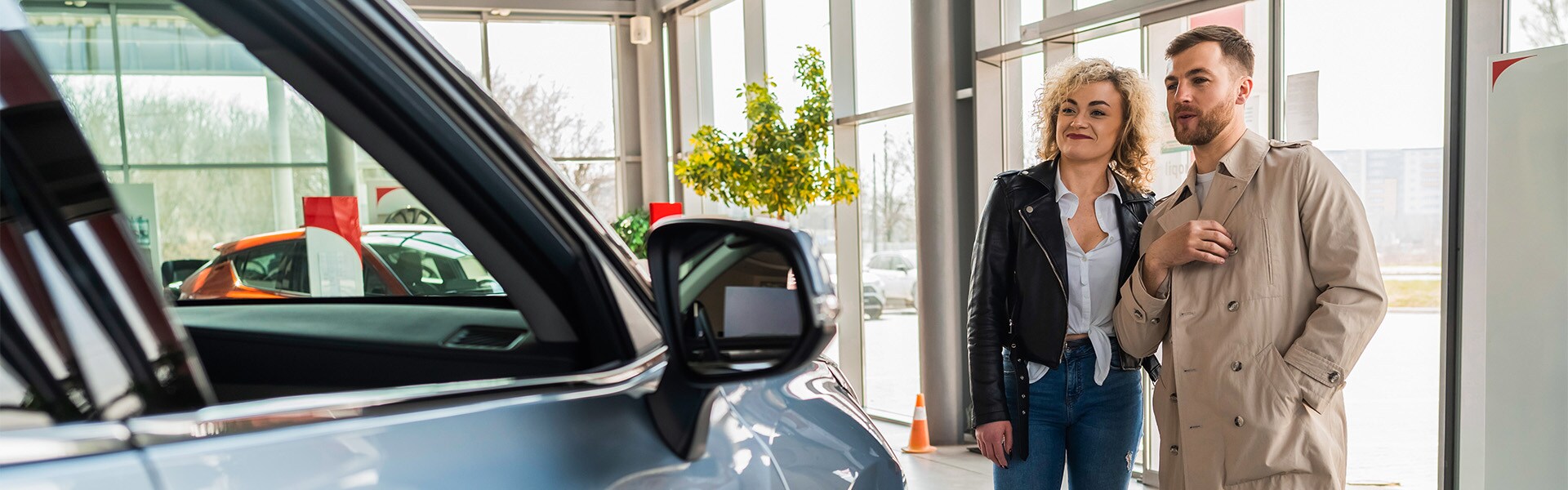 Haddad Toyota is a Toyota Dealership near Pittsfield, MA | Couple Looking at Car on Sales Floor of Car Dealership