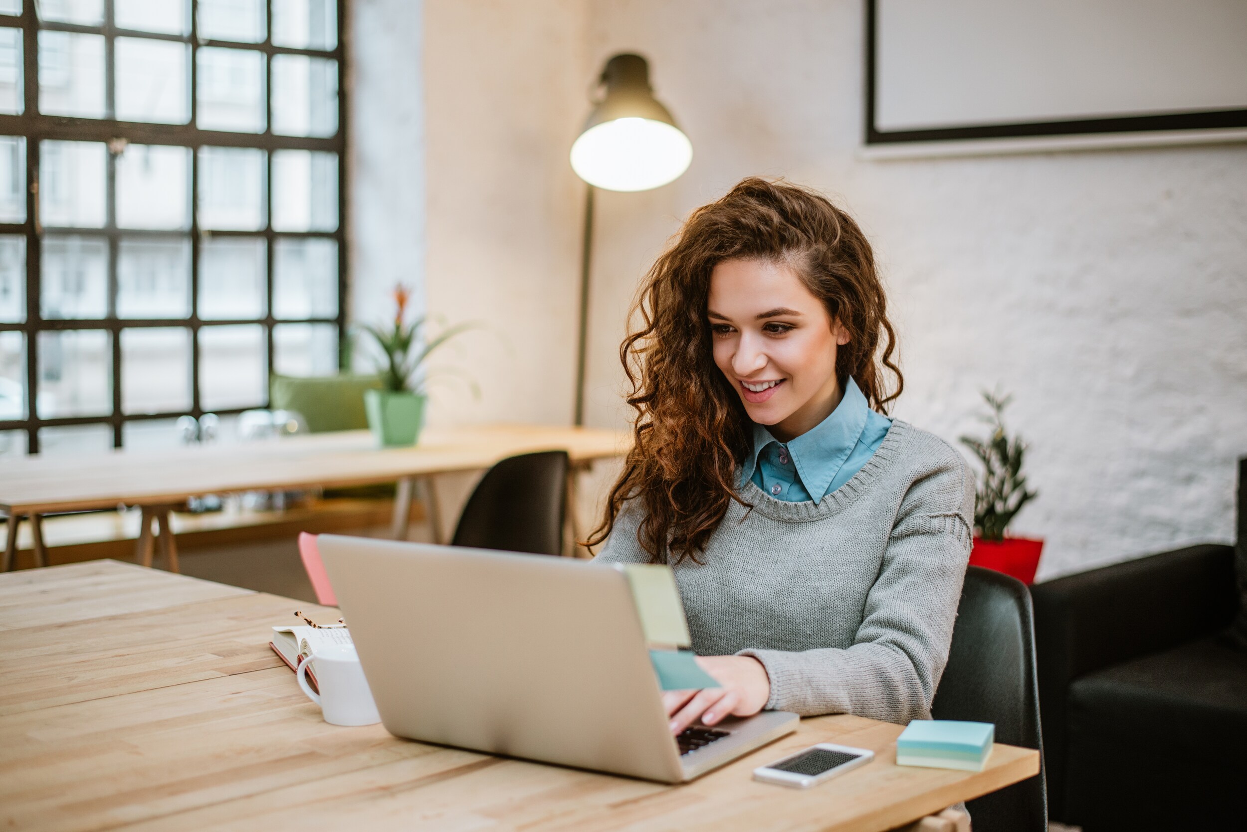 successful-young-woman-modern-office-working-laptop.jpg