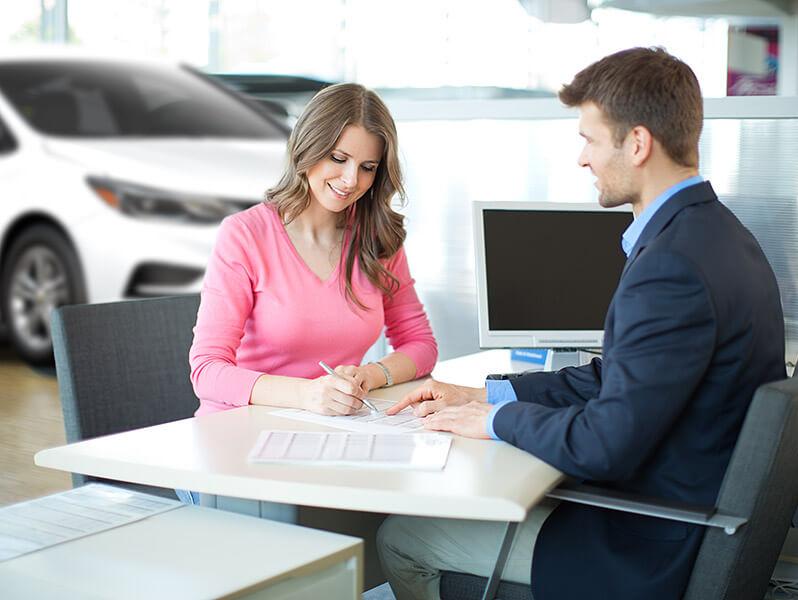 f2a4de1f0a134320953cd2fcb82cb437_c0x0-798x600.jpg Woman filling out the paperwork to purchase a new vehicle