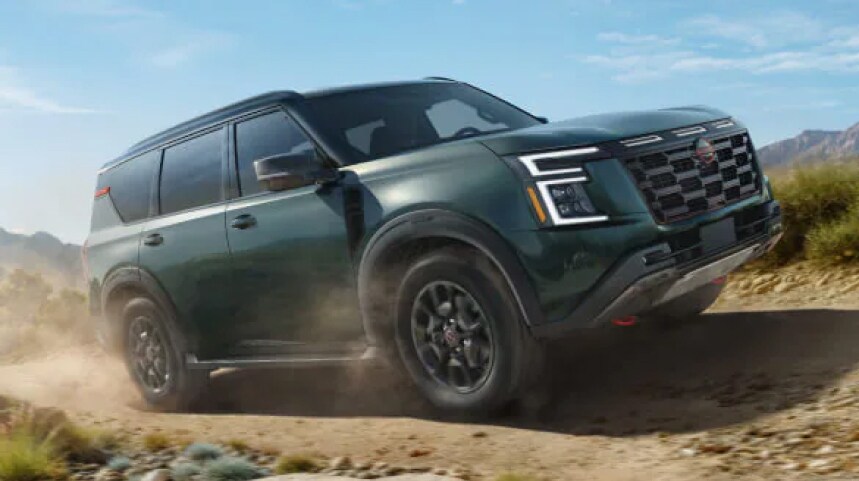 Green Nissan SUV driving offroad