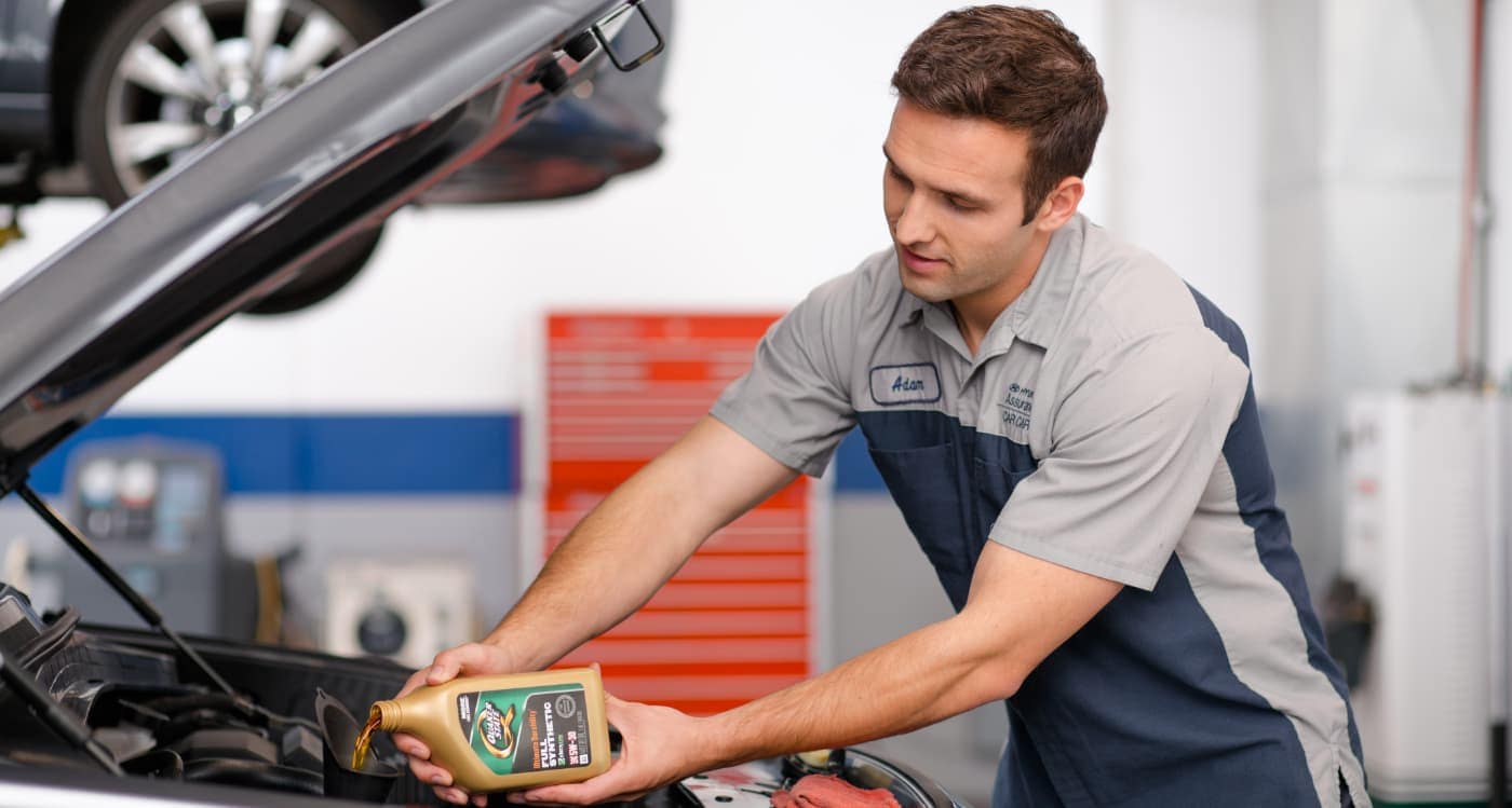 Service Specialist Changing Oil on a Vehicle