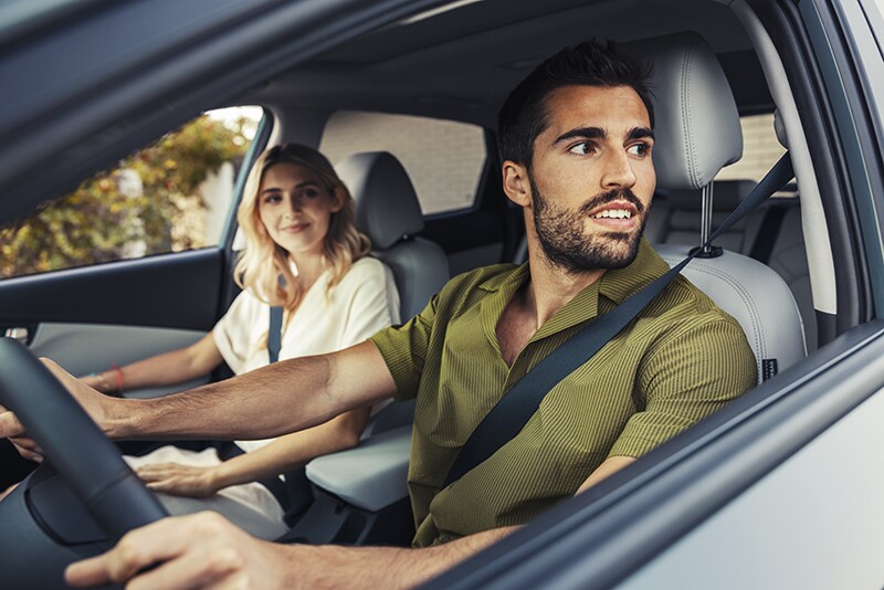 Still of a man and woman driving a 2022 Hyundai Kona EV
