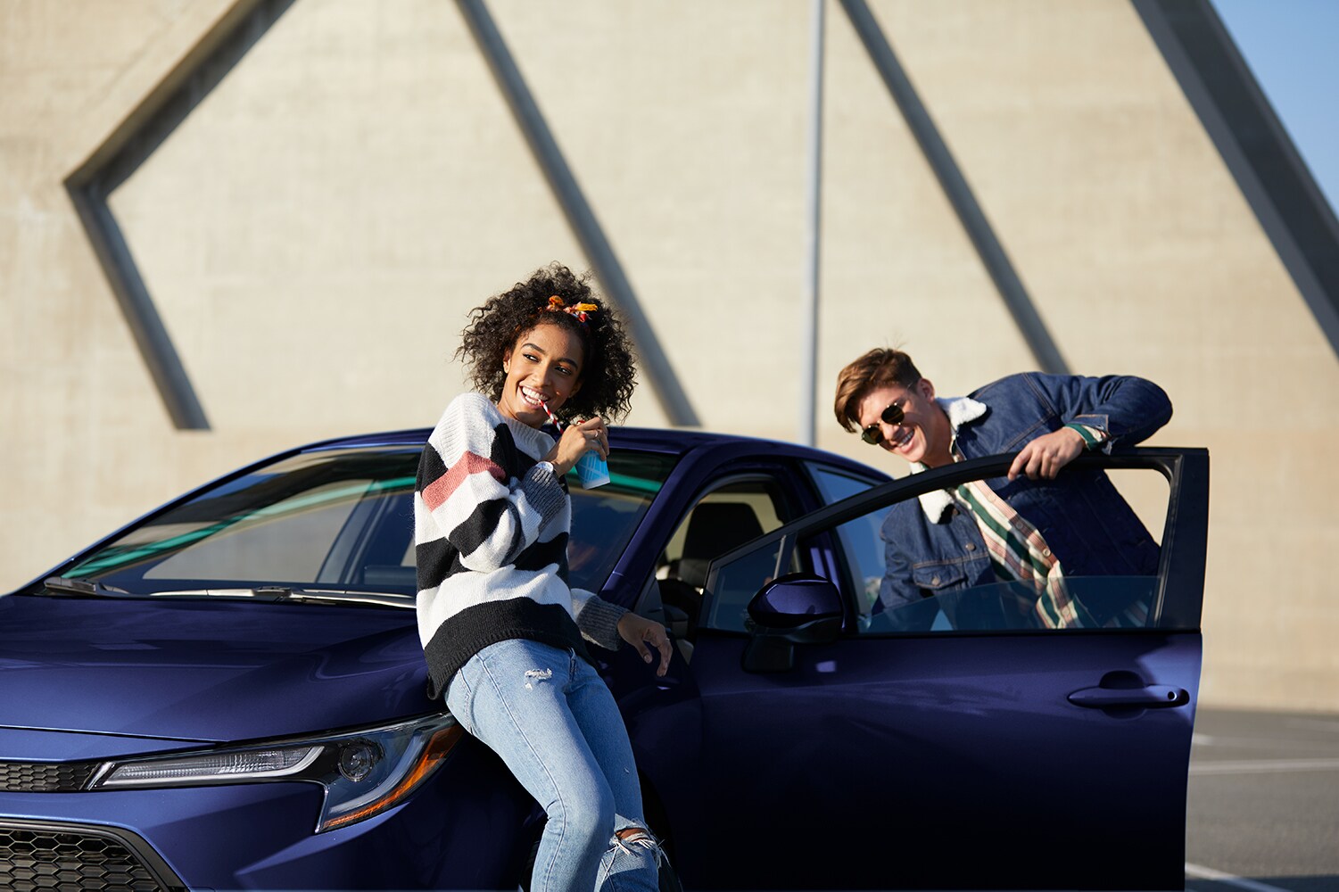 Model Features of the 2020 Toyota Corolla at Hanover Toyota in Hanover | Teenager leaning on the purple 2020 toyota corolla Model Features of the 2020 Toyota Corolla at Hanover Toyota in Hanover | Teenager leaning on the purple 2020 toyota corolla