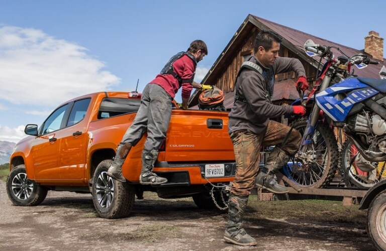 2022 Chevy Colorado orange back view towing recreational equipment