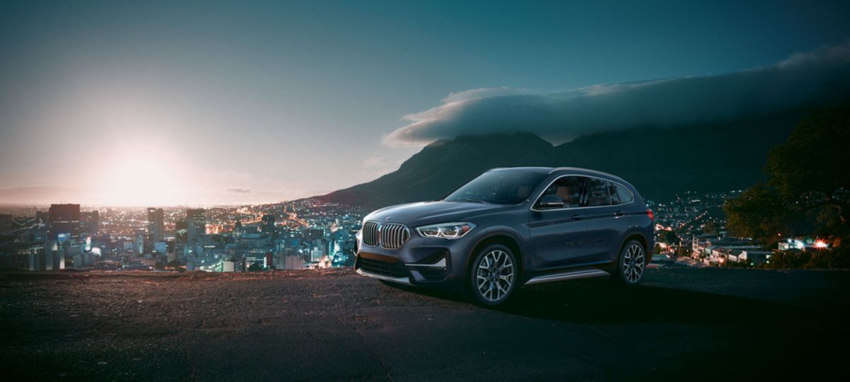 2021 BMW X1 sDrive28i parked on hill over cityscape_long.jpeg