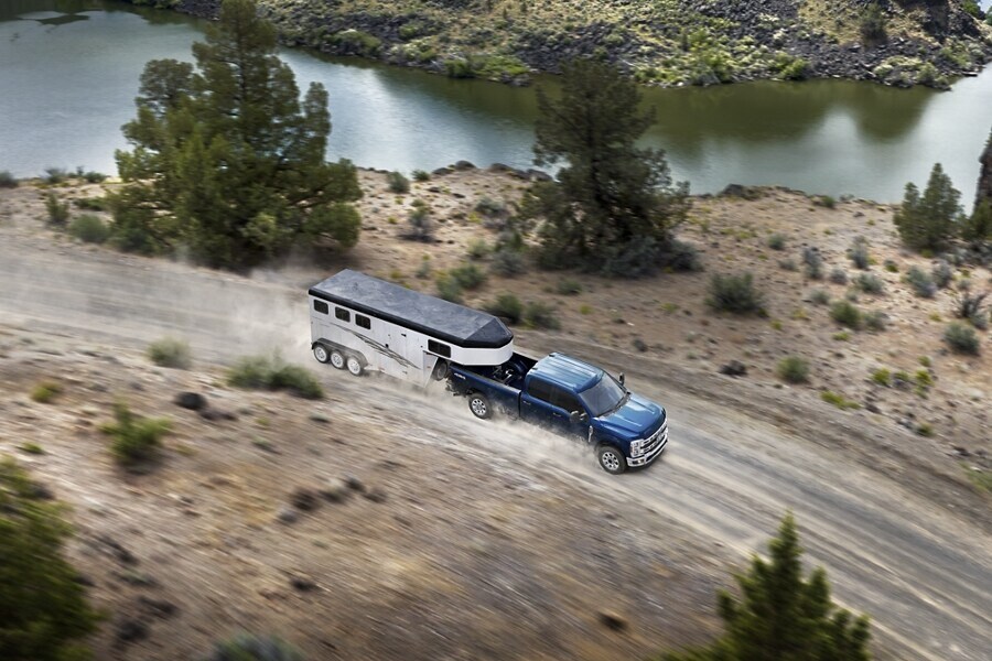 Ford Super Duty Towing Trailer on Dirt Road