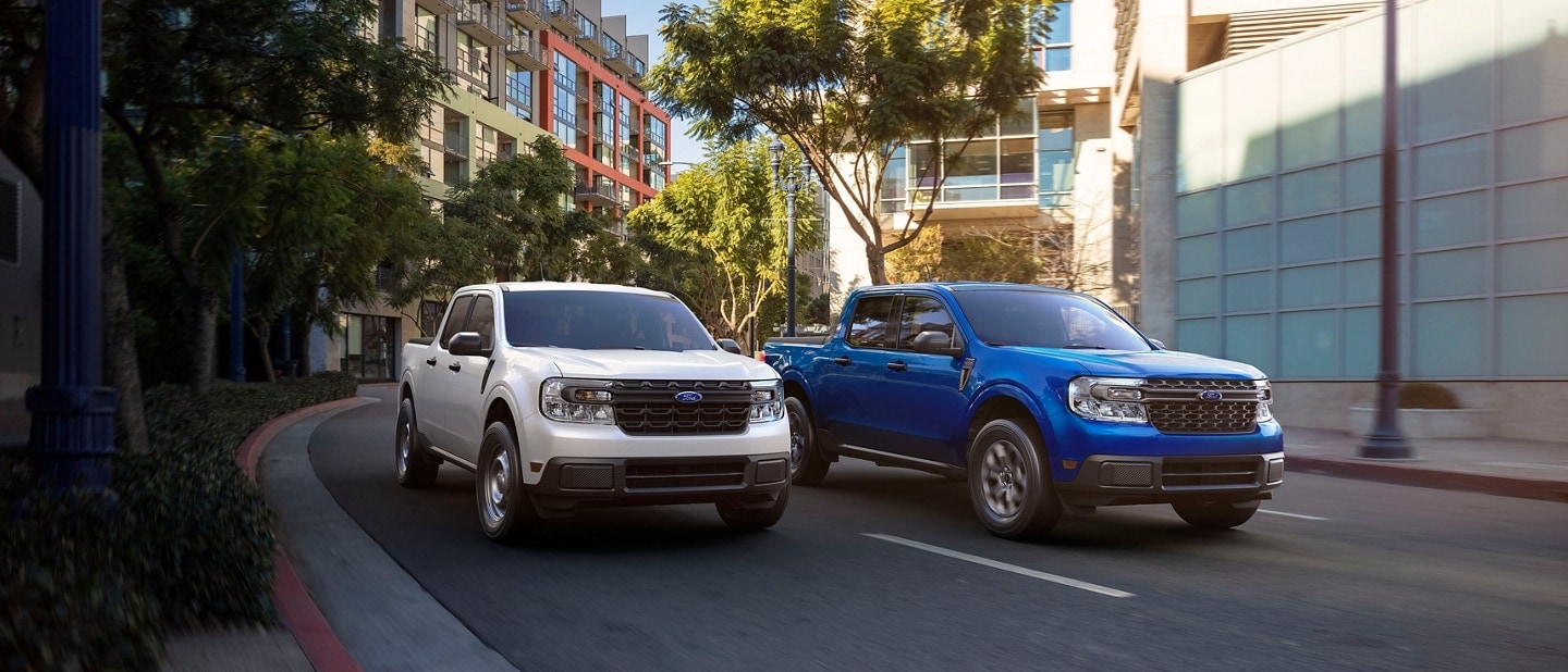 White and Blue Ford Maverick Driving Side by Side