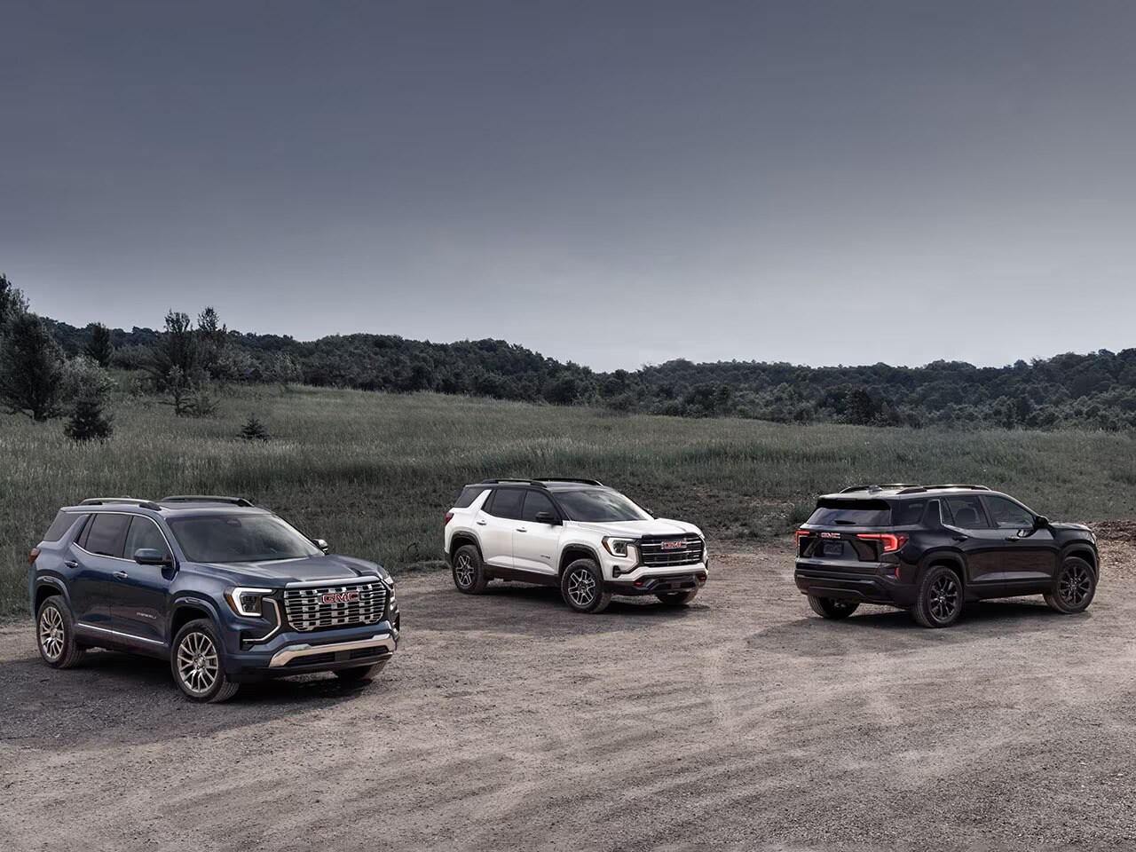 A collage of the different 2026 GMC Terrain trim levels: Elevation, AT4, and Denali.