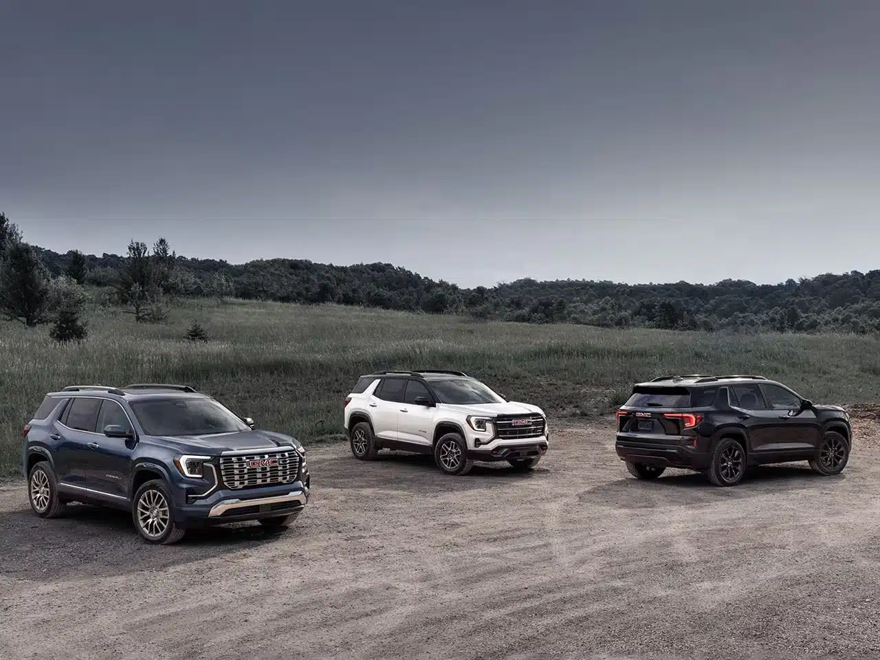 A collage of the different 2026 GMC Terrain trim levels: Elevation, AT4, and Denali.