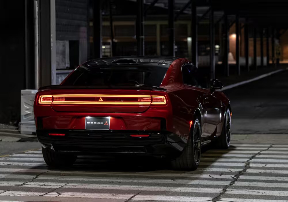 Dynamic low-angle shot of the 2026 Dodge Charger Daytona showing its fastback profile.